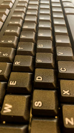 closeup shot of computer keyboard on wooden table