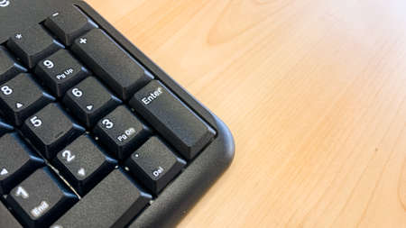 closeup shot of computer keyboard on wooden tableの写真素材