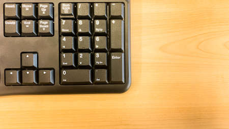 closeup shot of computer keyboard on wooden table