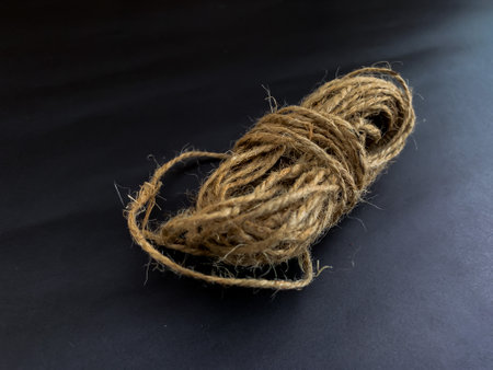 hemp rope rolled up on a black backgroundの写真素材