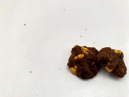 Pieces of chocolate cake with nuts on white paper