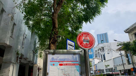 March 12, 2022 - Surabaya, Indonesia.a bus stop sign on the side of the city roadのeditorial素材