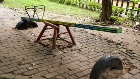 children's toy seesaw that is damaged and not maintained