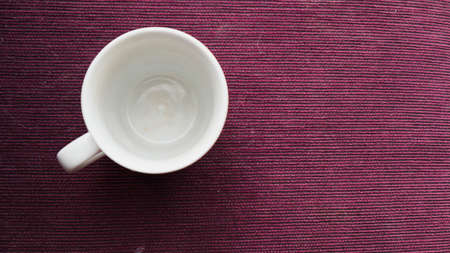 an empty white cup on a purple background