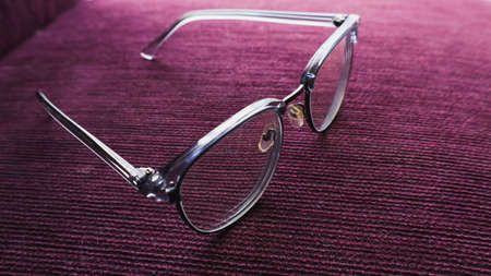 gray glasses on a purple backgroundの写真素材