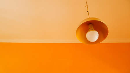 LED light that doesn't work in the living room, with orange wallsの写真素材