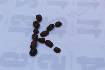 Coffee beans on a white background. Coffee beans on the background of the calendar.の写真素材