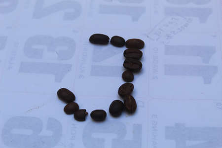 Coffee beans on the background of the calendar with the date of February 14の写真素材