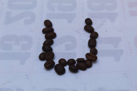 Coffee beans arranged in a circle on a background of numbers