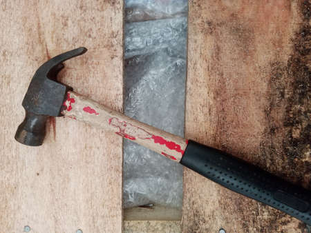 Hammer on a wooden board. The concept of repair work.の写真素材