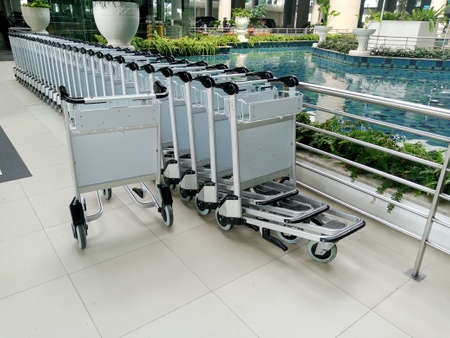 Luggage trolleys in the airport terminal. Traveling conceptの写真素材