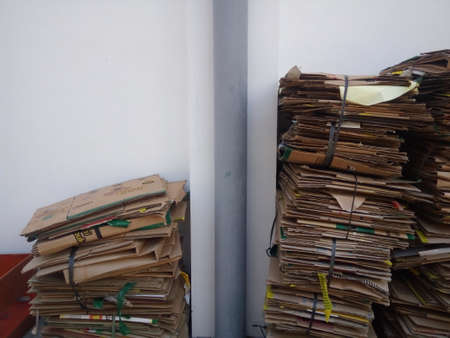Pile of old cardboard boxes in a storage area.の写真素材