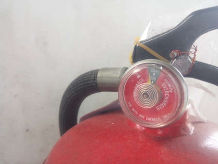 Red fire extinguisher on a white background. Close-up.の写真素材
