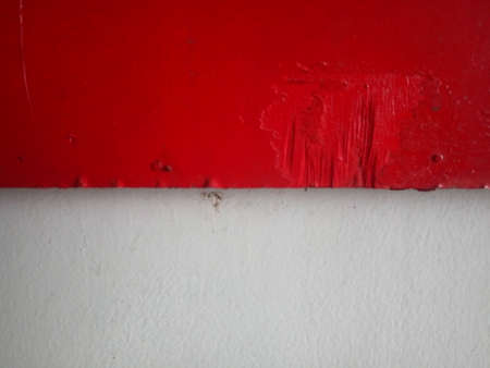 Red paint on a white wall. Abstract background and texture for design.の写真素材