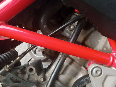 Close-up of the engine of a red motorcycle. Details of the vehicle.