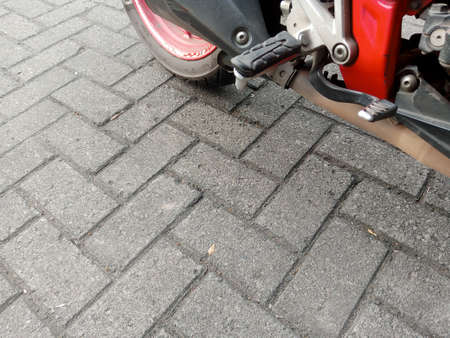 Close-up of the rear wheel of a modern electric scooter on the pavement.