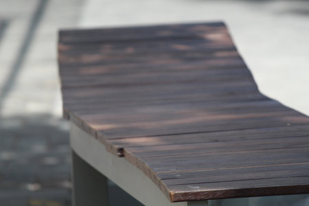 Wooden bench in the park. Selective focus, shallow depth of field.