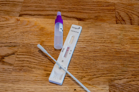 BAMBERG, GERMANY - 8.4.2021. Covid-19 antigen saliva test Kit with plastic specimen for a rapid...