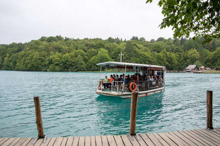 Plitvice Lake National Park, Croatia - 17.8.2021. River boat in front of the pier at Plitvice Lakes National Park, Croatia.のeditorial素材
