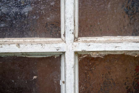 Patterned blurred window glass with cross frame in white