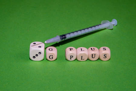 Concept Image for 2G plus and 3G plus control, white cubes form 2G and 3G and the word plus against a green backgroundの写真素材