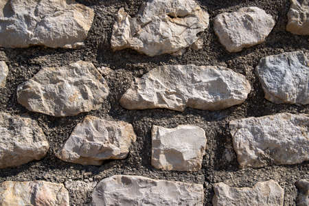 Wall made of mortar and natural stones as background or textureの写真素材