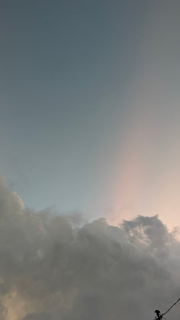 A stunning cloudscape at dusk, showcasing the transition from day to night. Soft, pastel hues blend...