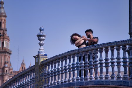 Multi-ethnic young couple doing figures while dancing bachata sensually outdoors.の写真素材