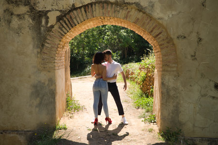 Attractive young couple in love, looking into each other's eyes, faces close together about to kiss, in an outdoor park. Concept love, passion, desire, lovers, valentine, kiss.の写真素材