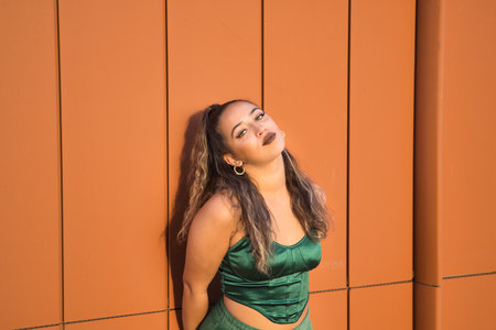 Latin and Hispanic girl, young and beautiful, with green eyes and large eyelashes, looking at the camera in a sensual and provocative attitude. Concept beauty, fashion, provocation, sensuality.の写真素材