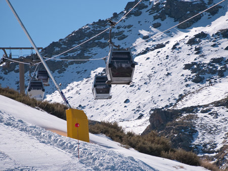 Gondolas that go to the top of the ski resort so that skiers and snowboarders can start the descent of the slope. Concept snow, sport, resort, winter.の写真素材