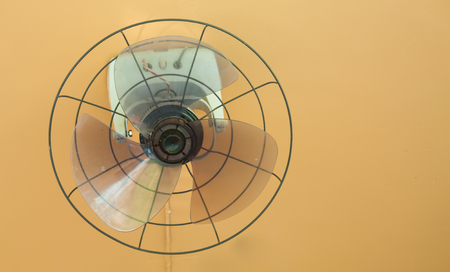 Old wall fan without grille and orange wallの写真素材