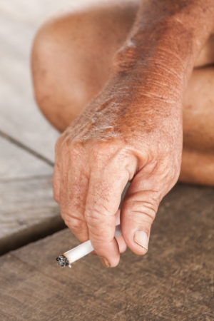 Hand of an asian old man holding a cigaretteの写真素材