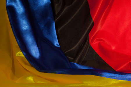 yellow-blue and red-black Ukrainian flag as backgroundの写真素材