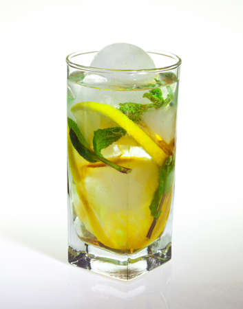 drops of rose on a glass of cold drink with ice, lemon and mint on a white backgroundの写真素材