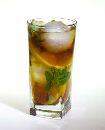 drops of rose on a glass of cold drink with ice, lemon and mint on a white backgroundの写真素材