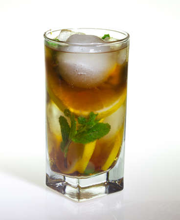 drops of rose on a glass of cold drink with ice, lemon and mint on a white backgroundの写真素材