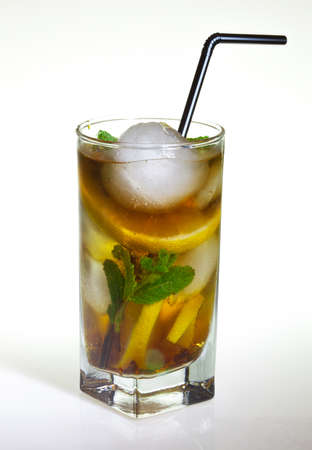 drops of rose on a glass of cold drink with ice, lemon and mint on a white backgroundの写真素材