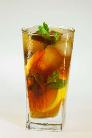 drops of rose on a glass of cold drink with ice, lemon and mint on a white backgroundの写真素材