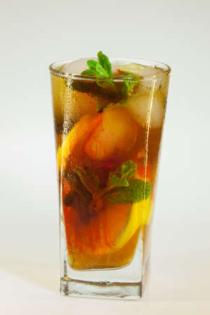 drops of rose on a glass of cold drink with ice, lemon and mint on a white backgroundの写真素材