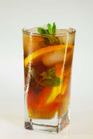 drops of rose on a glass of cold drink with ice, lemon and mint on a white backgroundの写真素材