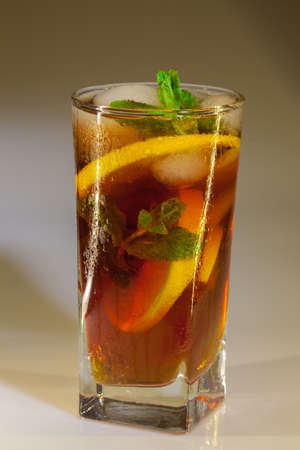 drops of rose on a glass of cold drink with ice, lemon and mint on a white backgroundの写真素材