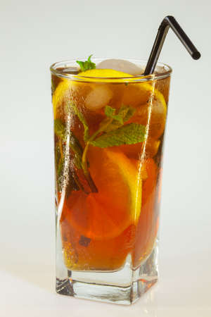 drops of rose on a glass of cold drink with ice, lemon and mint on a white backgroundの写真素材