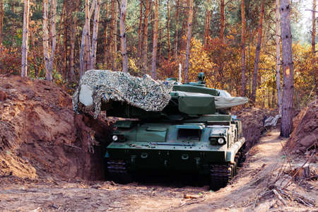 real battle tanks disguised in the trenches Donbass Ukraineの写真素材