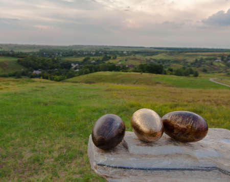 concept egg handmade lies on white marble stone opposite village backgroundの写真素材