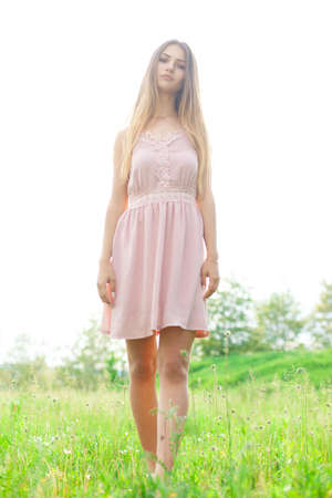 sexual girl has dissolved long hair sunny in the afternoon opposite blossoming white acaciaの写真素材