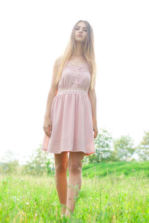 sexual girl has dissolved long hair sunny in the afternoon opposite blossoming white acaciaの写真素材