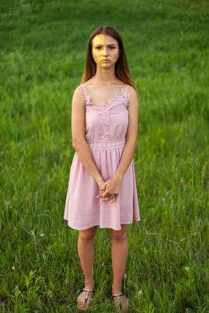 sexual girl has dissolved long hair sunny in the afternoon opposite blossoming white acaciaの写真素材