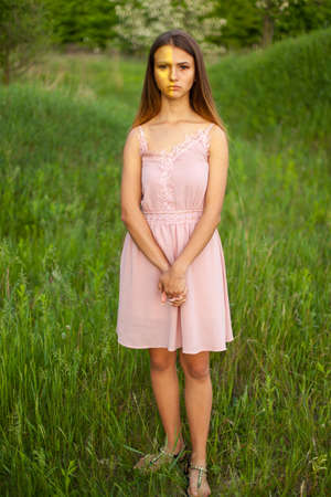 sexual girl has dissolved long hair sunny in the afternoon opposite blossoming white acaciaの写真素材