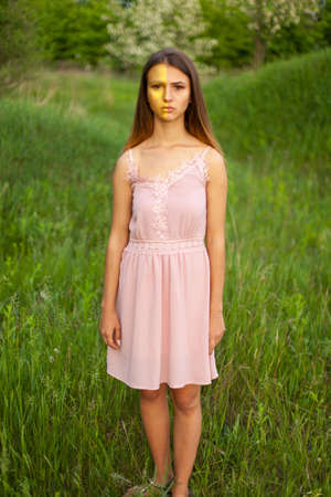 sexual girl has dissolved long hair sunny in the afternoon opposite blossoming white acaciaの写真素材